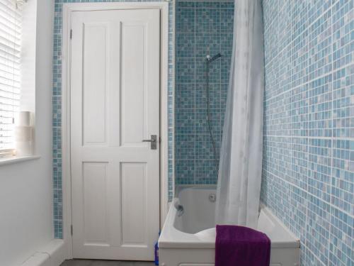 a bathroom with a tub and a toilet and a shower at Hill Farm Cottage in Stretham