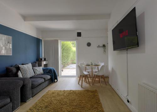 a living room with a couch and a table at Ryland House Sleeps 8 M6 Access & Garden in Birmingham