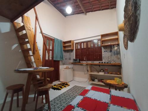 a small kitchen with a staircase in a room at Canto Ybykuara - Natural Guest House in Ibicoara