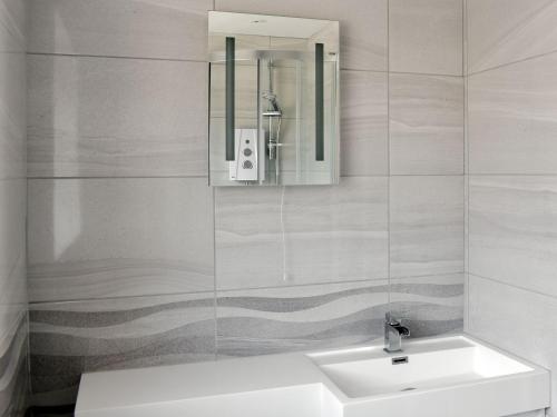 a bathroom with a sink and a mirror at Newhope in Winchelsea