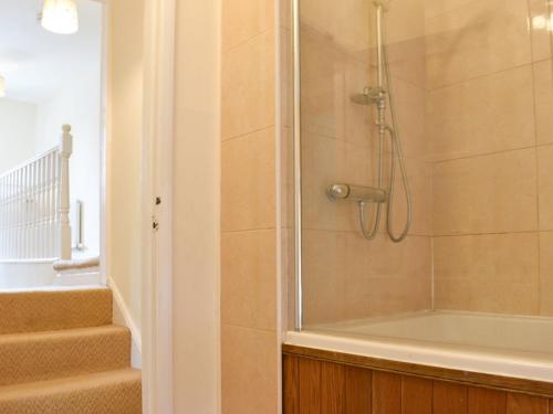 a bathroom with a shower and a bath tub at Ellerton House in Richmond