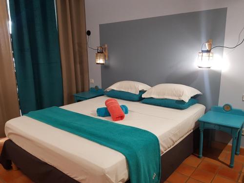 a bedroom with a bed with two pillows on it at Les Studios de la Baie 246 in La Trinité
