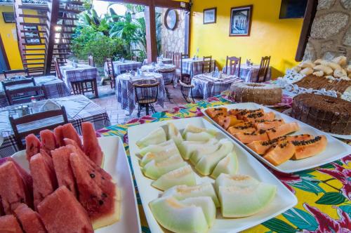 a table with two trays of different types of food at Pousada Konquista in Paraty