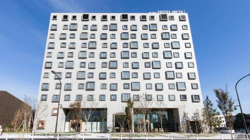 a white building with a lot of windows at JR East Hotel Mets Premier Tokyo Bay Shinkiba in Tokyo