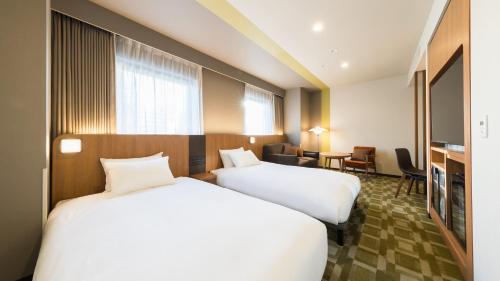 Postel nebo postele na pokoji v ubytování JR-East Hotel Mets Akabane
