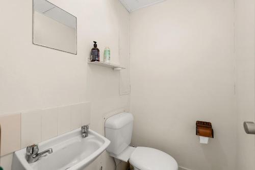 a white bathroom with a toilet and a sink at Triview Mitchell Street Unit 4 1 Soldiers Point in Soldiers Point