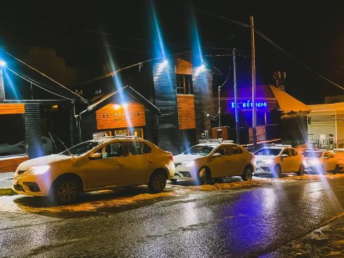 a group of cars parked on a street at night at El Refugio Lodge Hostel in Ushuaia