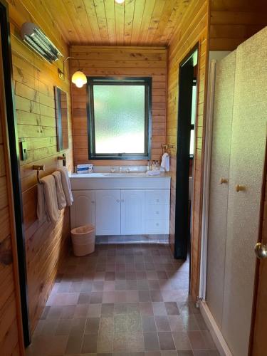 a bathroom with a sink and a window at Lakes Lodge Okataina in Rotorua