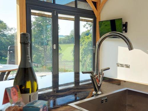 a kitchen with a sink and a bottle of wine at The Hideaway in Highgate