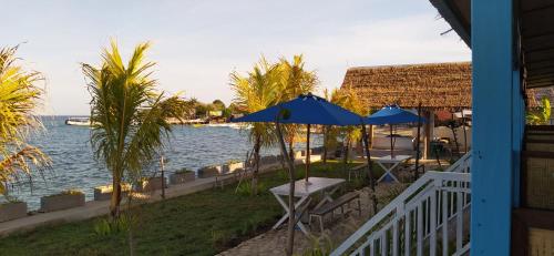 a view of the water from a house with umbrellas at Moyo Island Resort in Moyo Island