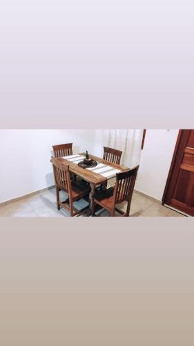 a table and two chairs in a room at La Plaza in Formosa