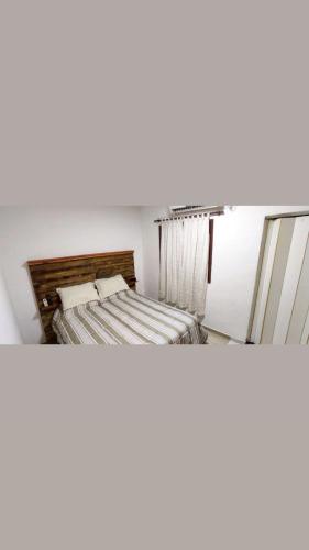 two photos of a bed in a small room at La Plaza in Formosa