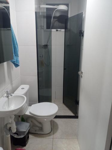 a bathroom with a shower and a toilet and a sink at Condomínio ágata in São Paulo