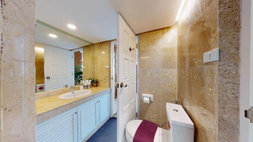 a bathroom with a sink and a toilet and a mirror at Mountain & City View Panorama at Nimman in Chiang Mai