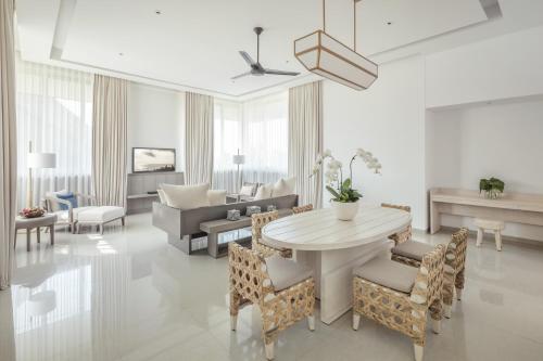 a living room with a table and chairs at COMO Uma Canggu - CHSE Certified in Canggu