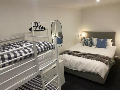 a bedroom with two bunk beds and a mirror at Arlberg 314 in Mount Buller