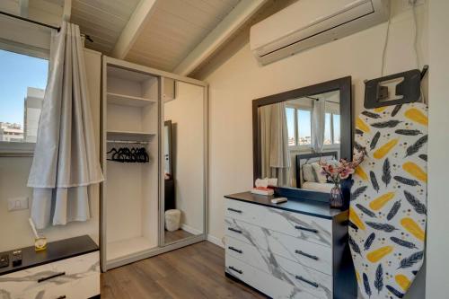 a bathroom with a dresser and a mirror at LUXURY PENTHOUSE GREAT LOCATION WITH PARKING Tlv in Ramat Gan
