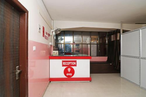 a fast food restaurant with a red and white counter at Prabha Palace Lodge in Kamakhya