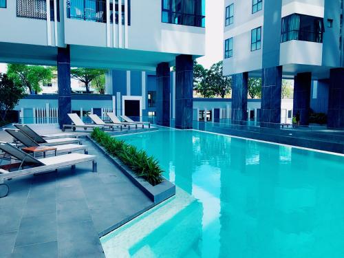 a swimming pool in the middle of a building at THE BASE holiday in in Pattaya Central