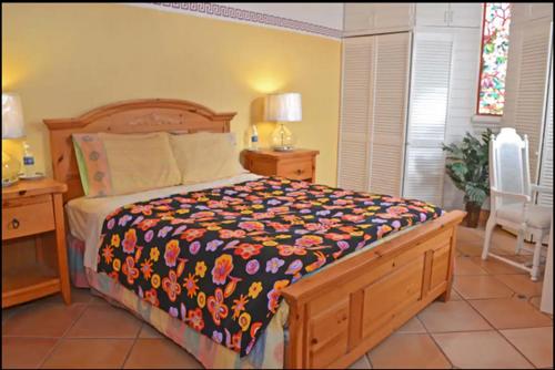 a bedroom with a bed and two tables and a chair at Welcome To Casa OLE Playas de Tijuana 5-Rooms 14-Guests close to Shoping Center & Beach in Tijuana