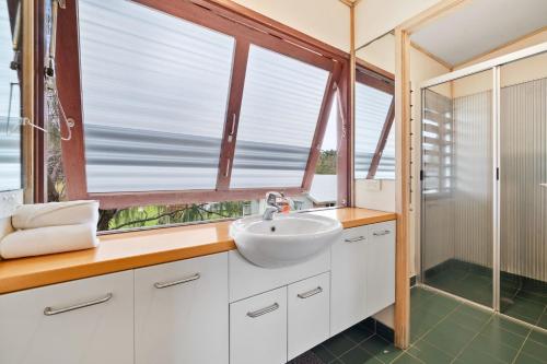 a bathroom with a sink and a window at Laguna in Point Lookout