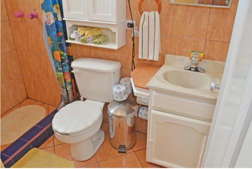 a small bathroom with a toilet and a sink at Welcome To Casa OLE Playas de Tijuana 5-Rooms 14-Guests close to Shoping Center & Beach in Tijuana