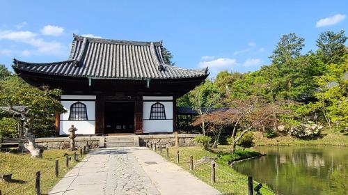 a pagoda in a garden next to a pond at ibis Styles Kyoto Shijo in Kyoto