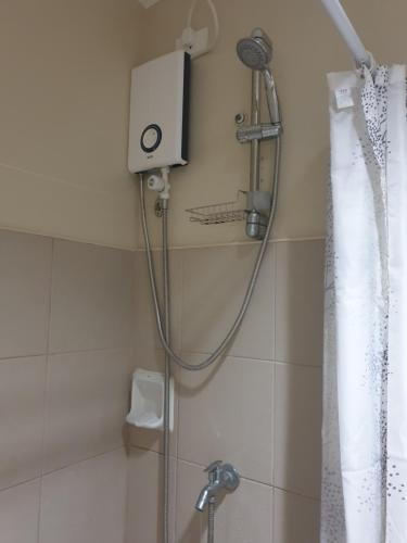 a shower with a shower head in a bathroom at CunduNiAia Sunvida Tower Condominium Unit Across SM Cebu in Cebu City