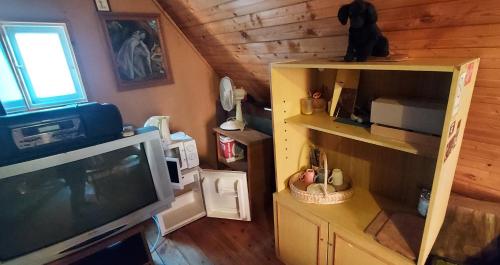 a living room with a tv and a room with a room at Studentiški apartamentai Palangoje in Palanga