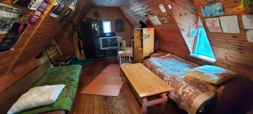 a room with two beds and a table in a cabin at Studentiški apartamentai Palangoje in Palanga