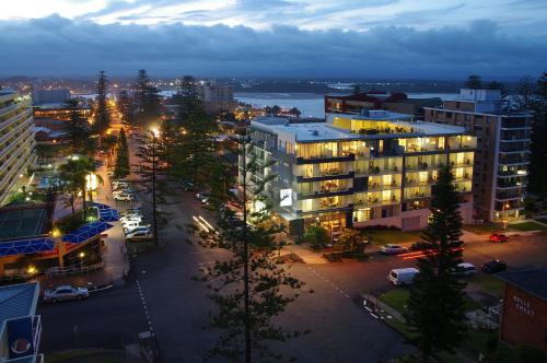 a view of a city at night with buildings at Macquarie Waters Boutique Apartment Hotel in Port Macquarie