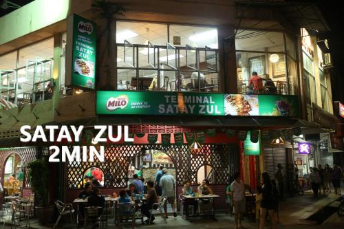 people sitting at tables outside of a restaurant at night at Mujito 8PAX NearTC, DinosaurLand, PoolTable, PS4 in Kuantan