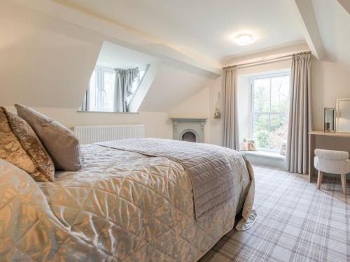 a bedroom with a large bed and a fireplace at Woodhaven - Uk1517 in Grange Over Sands