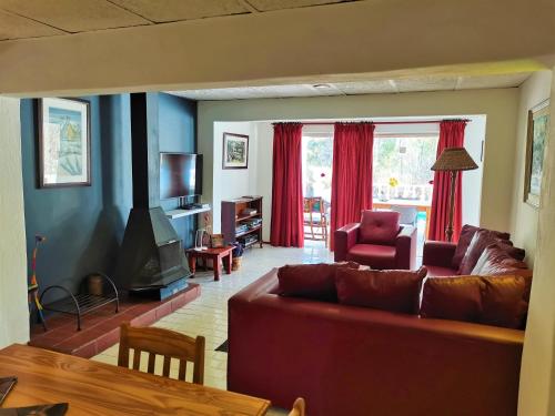 a living room with a couch and a tv at Otters' Haunt Eco Retreat in Parys