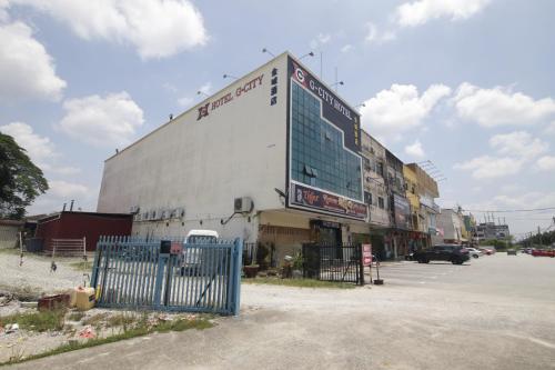a building with a sign on the side of it at G CITY HOTEL in Teluk Intan