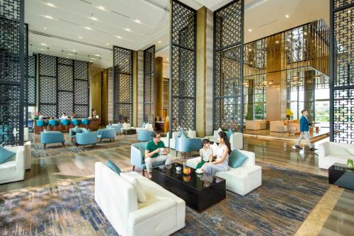 people sitting in the lobby of a hotel at FLC Grand Hotel Samson in Sầm Sơn