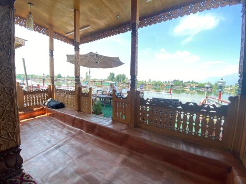 a porch with a view of the water at Lake Palace Group Of House Boats in Srinagar