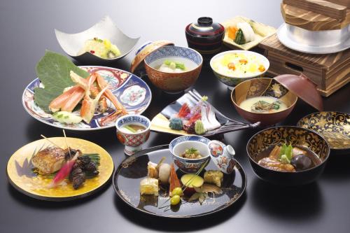 eine Gruppe von Lebensmittelplatten auf einem Tisch in der Unterkunft Kinjohro in Kanazawa