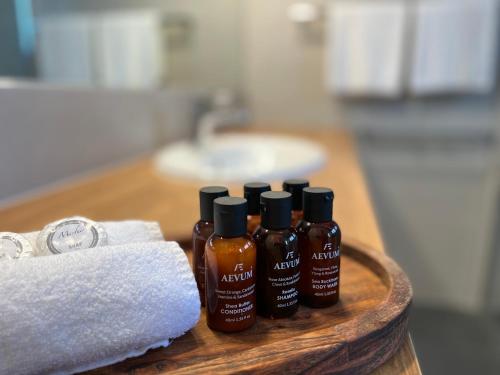 a group of four bottles of hair products on a table at Summerhill Motor Inn in Merimbula