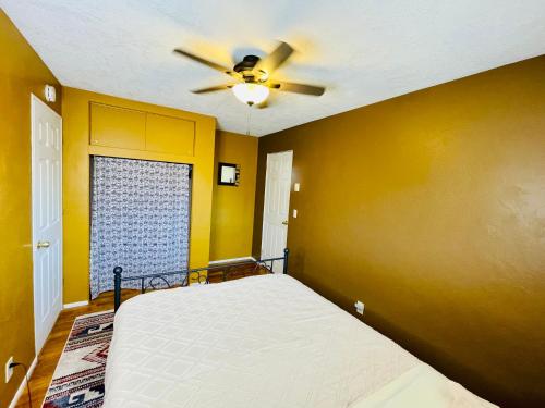 a bedroom with a bed and a ceiling fan at Colorful 50's Ranch in the Heart of Eugene in Eugene