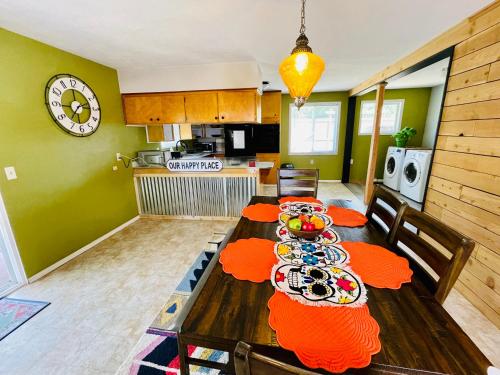 a dining room with a table with food on it at Colorful 50's Ranch in the Heart of Eugene in Eugene