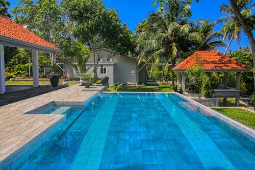 a swimming pool in the backyard of a villa at The Niche by DBI in Hikkaduwa