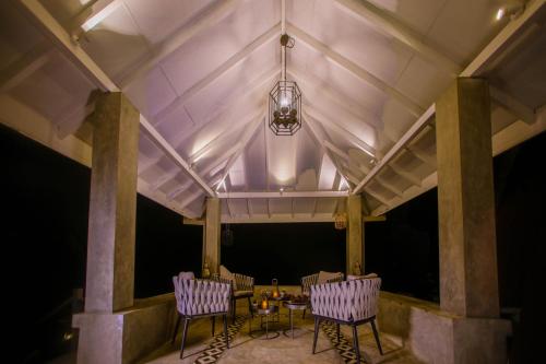 a room with a table and two chairs and a ceiling at The Niche Hikkaduwa - 10 minutes to the beach in Hikkaduwa