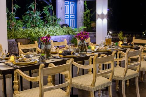 a long table with chairs and plates of food on it at The Niche Hikkaduwa - 10 minutes to the beach in Hikkaduwa