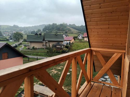 a view from the balcony of a log house at Motylowe Wzgórze Apartamenty Zawóz in Zawóz