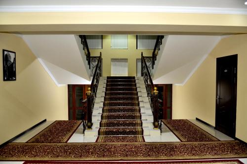 a stairway in a building with stairs leading up at Hotel Diyora in Samarkand