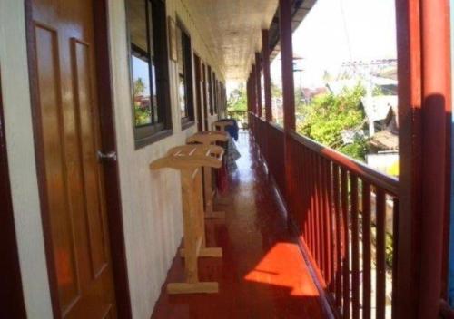 a corridor of a building with benches on a balcony at Phi Phi Dream Guest House in Phi Phi Islands