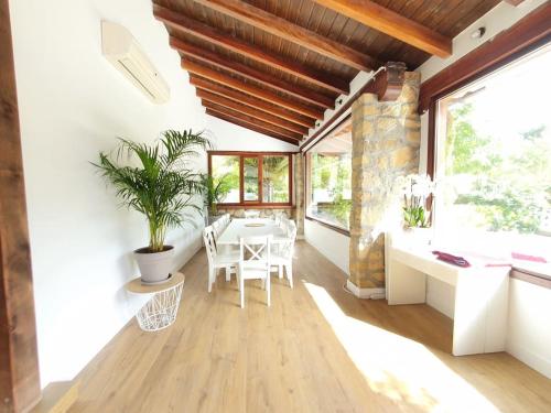 a dining room with a table and some windows at Dreams and friends on the coast of Bilbao. in Getxo