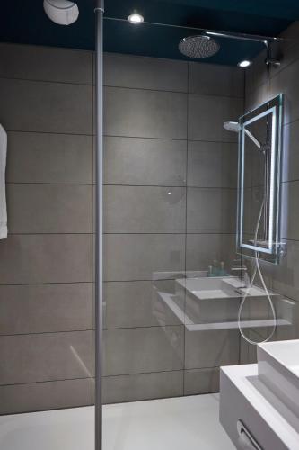 a bathroom with a shower and a sink at Novotel München City in Munich