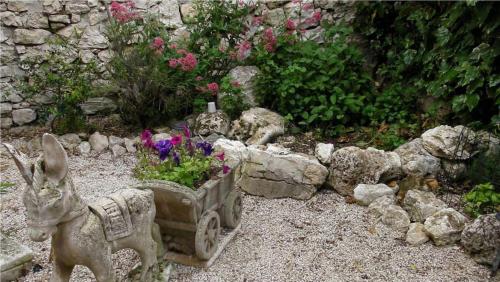a garden with a statue of a rabbit and flowers at Il Minotauro B&B a 5 minuti da Popoli in Vittorito